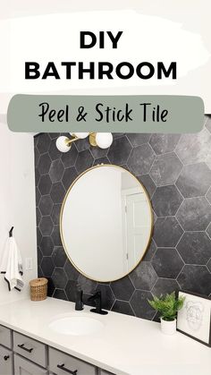 a bathroom with black and white tiles, gold accents and a round mirror on the wall