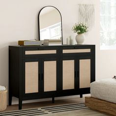 a black and beige sideboard with a mirror on it's top next to a bed