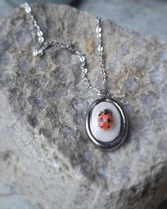 .:  Ceramic ladybug pendant silver necklace :. Give a adorable gift to someone you love or adorn yourself with something really unique and beautiful! This dainty ceramic ladybug pendant are made of ceramic clay and glazed with ceramic glazes. The pendant have been fired three times, during the last firing in the klin the pendant are glazed with platinum luster. Handmade, glazed and fired in my home studio. All ceramic jewels are hand painted, carved, and one-of-a-kind. Due to the handmade nature Ceramic Ladybug, Ladybug Necklace, Girlfriend Jewelry Gift, Ladybug Jewelry, Insect Necklace, Ceramic Pendant Necklace, Necklace Ceramic, Woodland Jewelry, Ceramic Glazes