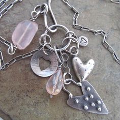 All the Hearts Charm Necklace Cluster Pink Rose Quartz Gemstone  Valentine's Day Gift Love Jewelry: A plethora of my original sterling silver heart charms is combined with chunky nuggets of pale pink Rose Quartz to create this unique necklace. These are suspended from a sterling chain that is approximately 22 1/2 inches in length and closes with a handmade hook. Hearts were made using a variety of techniques including stamping, piercing, casting and hand constructing. Perfect for Valentine's Day or any day! 100% hand made by me in my little home studio. Enter my shop: https://www.etsy.com/shop/artdi Join me on Facebook: https://www.facebook.com/Artdi-Diana-Anton-Jewelry-Design-44805607932/ Find me on Instagram: https://www.instagram.com/dianaantonjewelrydesign/ Pink Sterling Silver Charm Necklace With Heart Charm, Pink Sterling Silver Necklace With Heart Charm, Pink Heart-shaped Sterling Silver Charm Necklace, Silver Necklace With Heart Charm, Charming Silver Heart Necklace, Pink Heart Necklace With Dangling Charms, Sterling Silver Heart Charm Necklace For Jewelry Making, Pink Rose Quartz, Love Jewelry