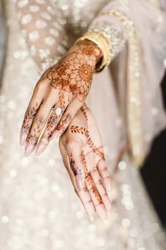 the bride's hands are decorated with hennap