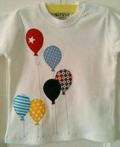 a t - shirt that has balloons on it