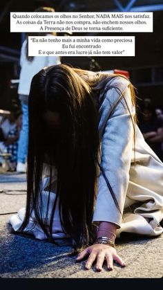 a woman with long hair laying on the ground