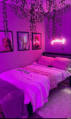 a bedroom with purple lighting and pictures on the wall