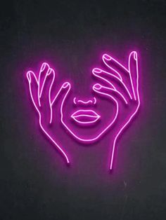 a woman's face with her hands up in the air, lit by neon lights