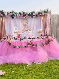 a teddy bear themed birthday party with pink tulle skirts and flowers on the table