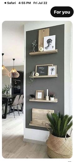 an image of a dining room with shelves on the wall and pictures on the wall