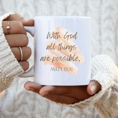 a woman holding a coffee mug with the words, wait god all things are possible