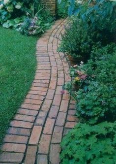 a brick path in the middle of a garden