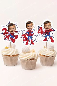 three cupcakes with spiderman toppers on them