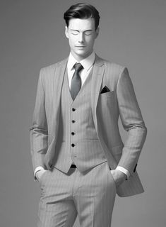 Indulge in understated opulence with the Napolean Genova Stripe Gray Wool Suit – a testament to sartorial finesse. Meticulously crafted from a lavish wool blend fabric, this suit boasts a refined texture in a serene gray hue, complemented by an exquisite stripe design. Its silhouette ensures a graceful cascade, catering to those who seek distinction without conforming to conventional notions of luxury. Whether in the executive boardroom, at upscale evening soirees beneath the stars, or amidst the celebration at weddings, this suit will stand as your distinguished companion.   Look Includes   Napolean Genova Stripe Gray Wool Fabric  Two Button Jacket Style  Notch Lapel  Horn Royal Black Buttons  Single Vent  Three Cuff Buttons  Two Welted Back Pockets on Trousers   Click 'Customize Now' to Elegant Tailored Three-piece Suit, Classic Fitted Blazer For Wedding, Elegant Single Breasted Semi-formal Suits, Elegant Single-breasted Semi-formal Suits, Elegant Tailored Wool Three-piece Suit, Elegant Three-piece Suit With Custom Fit And Suit Collar, Elegant Wool Three-piece Suit For Tailoring, Elegant Semi-formal Suit With Suit Collar, Elegant Fitted Suit With Pressed Crease