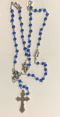 You are purchasing a very nice blue glass beads rosary of Saint Michael and the Archangel; Uriel, Raphael & Gabriel. Please see pictures for details. Approximate measurement: 21" long Pray the rosary or the Saint Michael Chaplets with this rosary as a reminder that Saint Michael the Archangel is the defender of evil, along with the other angels and with their intercession we can keep evil away. ********************************************************** If youwould like to learn more about the li Saint Michael The Archangel, Archangel Uriel, Pray The Rosary, Beads Rosary, Michael The Archangel, Praying The Rosary, Saint Michael, The Rosary, Holy Family