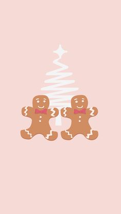 two gingerbreads sitting next to each other on a pink background