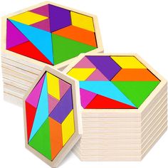 three wooden blocks with different colored shapes on them