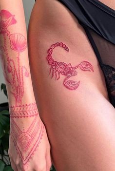 a close up of a person's thigh with tattoos on her leg and arm