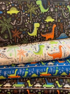 a pile of fabric with dinosaurs on them