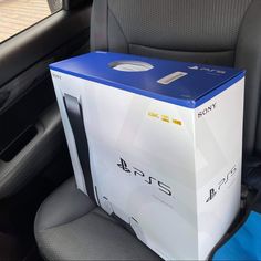 a playstation box sitting in the back seat of a car