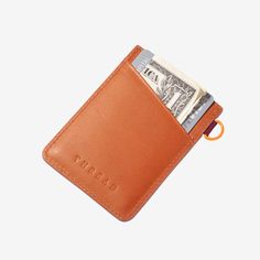 Our patented Vertical Wallet is a slim leather wallet equipped with our signature elastic pocket, which not only fits tightly around your cards but also gives the wallet a unique style. This Thread® wallet features RFID-secure technology to protect your credit card information. Thread Wallets, Tote Bag Organizer, Keychain Clip, Slim Leather Wallet, Wrist Lanyard, Lip Balm Holder, Utility Tote, Pouch Organizer, Backpack Tote Bag