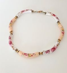 6.00 cm long white and beige ceramic beads, painted with romantic flowers, consist a girlish, romantic short necklace, made in the '80s. Each bead is a small piece of art and together they create a very beautiful, easy to wear, necklace. Total length 44.00 cm, stands high at the neckline. Simple and elegant, the ultimate spring and summer necklace for your light dresses. The necklace is not new, so there can be time signs on it. In perfect condition. Bohemian White Hand Painted Necklace, Light Dresses, Boho Statement Necklace, Beige Ceramic, Flowers Decoration, Light Dress, Romantic Flowers, Summer Necklace, Mothers Day Presents