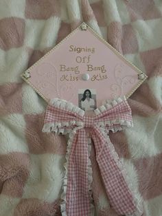 a pink and white graduation cap with the words, sing off bang bang kiss kisses