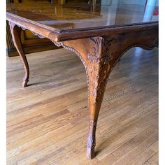 an old wooden table with glass top on the floor