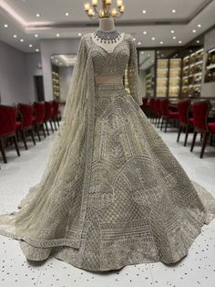 a dress on display in a room with red chairs