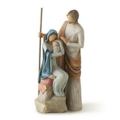 a figurine of a man and woman sitting on a rock next to each other