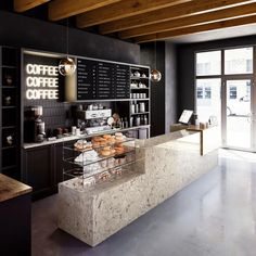 a counter in a coffee shop with donuts on it