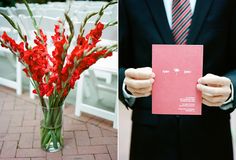 a man in a suit holding a red card next to a vase filled with red flowers