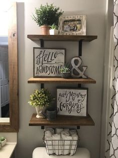 the bathroom is decorated with wood shelves and pictures on them, as well as other decorations