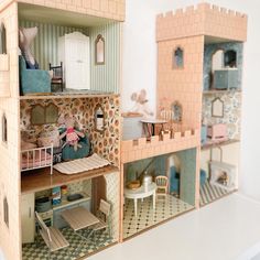 a doll house with furniture and accessories on the inside, as well as dolls in it