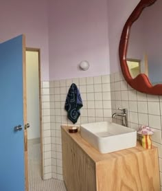 a bathroom with pink walls and white tiles