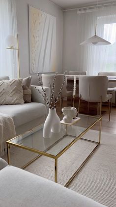 a living room filled with furniture and a glass table