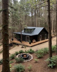 a cabin in the woods with a fire pit