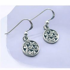 Discover the timeless elegance of our 925 Sterling Silver Triskelion Hook Earrings, an exquisite addition to any jewelry collection. Crafted with meticulous attention to detail, these earrings feature the ancient triskelion symbol, representing motion, progress, and the cycle of life. Made from high-quality 925 sterling silver, each piece is stamped with the 925 hallmark, ensuring its authenticity and superior craftsmanship. Measuring 7/16 inches in width and 1 1/32 inches in length, these earri Round Engraved Sterling Silver Earrings, Engraved Sterling Silver Round Earrings, Engraved Sterling Silver Earrings, Symbolic Sterling Silver Drop Earrings, Sterling Silver Earrings With Silver Clasp, Symbolic Sterling Silver Pierced Earrings, Symbolic Sterling Silver Jewelry For Formal Occasions, Classic Sterling Silver Earrings, Classic Sterling Silver Pierced Earrings