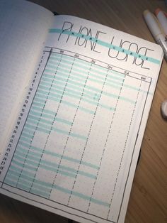 an open notebook with some pens on top of it and a phone usage chart in the middle