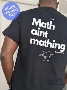 The Math aint mathing! Simple as that really lol. Enjoy this shirt while you wear it as I am sure you will have many people relating to this fun but growingly common saying! Sizing recommendation: Size up for a more relaxed fit Made to order  Size chart is in images 100% cotton Sport Grey 90% cotton, 10% polyester Gender-Neutral Adult Clothing We do not accept returns or exchanges on printed merchandise. These are made to order. Please carefully review your size and variation, before checking ou Funny Black Shirt With Graphic Design, Funny Black T-shirt With Graphic Design, Cotton T-shirt With Graphic Design For Fan Merchandise, Cotton T-shirt With Graphic Design For Fans, Black Logo Print Tops In Ring-spun Cotton, Black Ring-spun Cotton Top With Logo Print, Funny Graphic T-shirt For Fans, Funny Graphic Design T-shirt For Fans, Short Sleeve Tops With Logo Print In Ring-spun Cotton