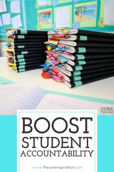 a stack of books sitting on top of a desk next to an open book with the title