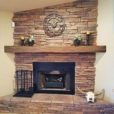 a stone fireplace with a clock on the mantle