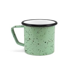 a green and black speckled coffee mug with a black rim on the outside, sitting in front of a white background