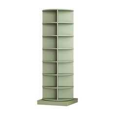 a tall green shelf with many shelves on it