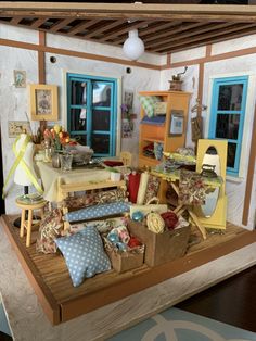 a doll house with furniture and accessories on display