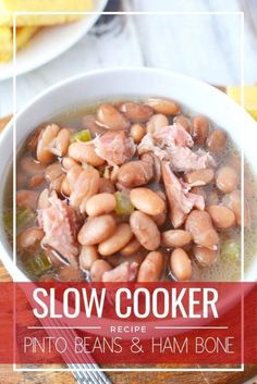 a bowl of slow cooker pinto beans and ham bone soup on a wooden table