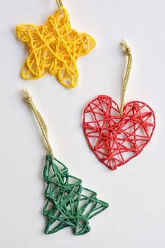 three ornaments made out of string on a white surface with the shape of a heart and star