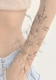 a woman's arm with flowers on it