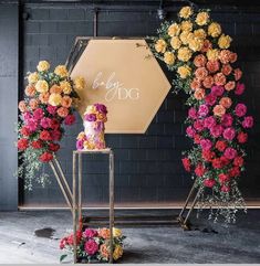 a display with flowers and a sign that says baby dog on it's side