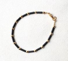 We couldn't love this more! Raven is gorgeous! Made with black bugle beads and 3mm metal beads of your choice! We offer sterling silver, gold plated or gold filled.  We suggest measuring your wrist with a soft measuring tape before ordering.  *Note gold plated will tarnish if exposed to water and/or chemicals. Raven Bracelet, Black And Gold Jewelry, Kids Gold Jewelry, Mom Bracelet, Black Beads Mangalsutra, Black Beads Mangalsutra Design, Gold Jewelry Outfits, Anklet Designs, Beads Designs