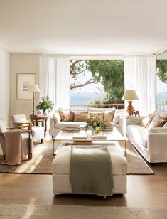 a living room filled with furniture and lots of windows