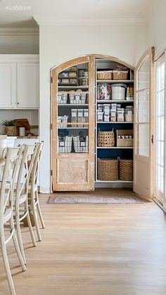 a large open pantry in the middle of a room with many chairs and tables around it