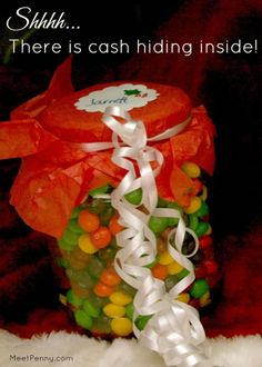 there is a jar filled with gummy bears and ribbon tied around the top that says, sushi there is cash hiding inside